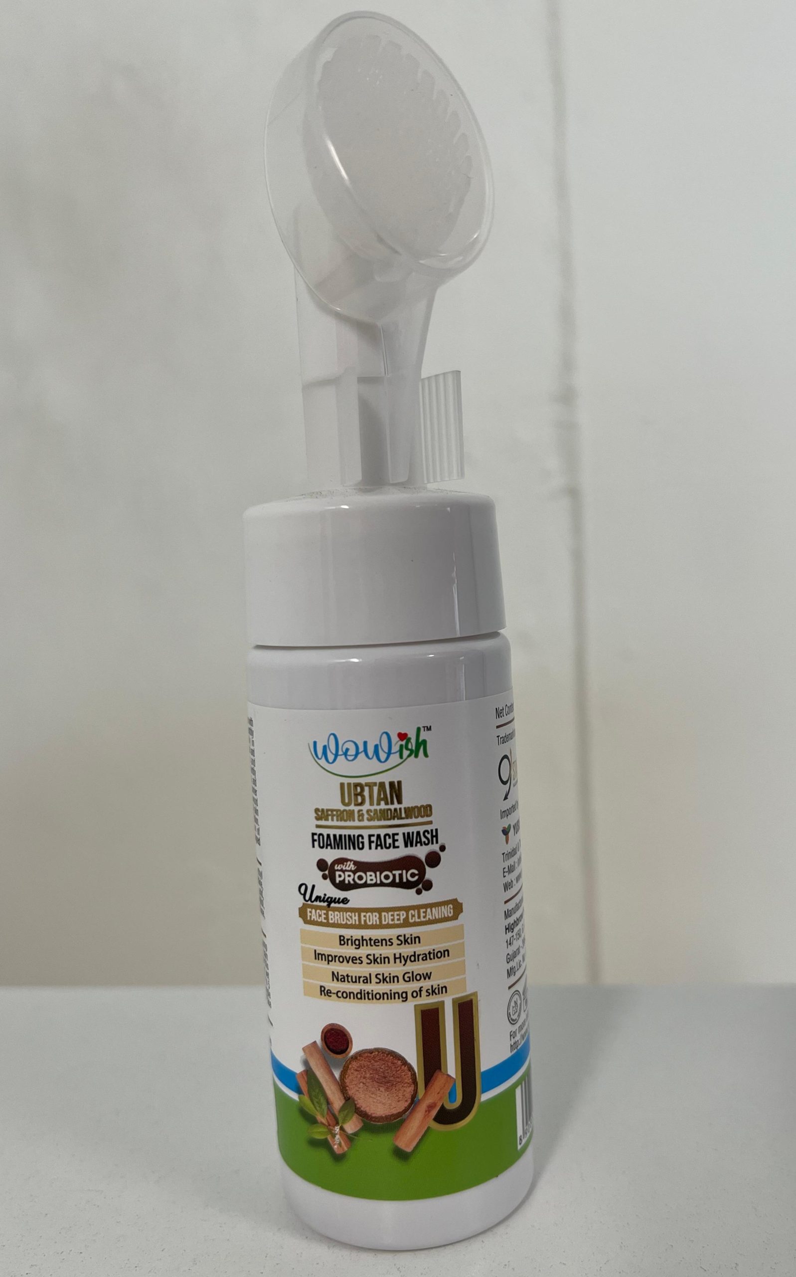 Front view of Wowish Ubtan Foaming Face Wash with saffron and sandalwood, featuring built-in face brush and probiotic formula for brightening and hydration.