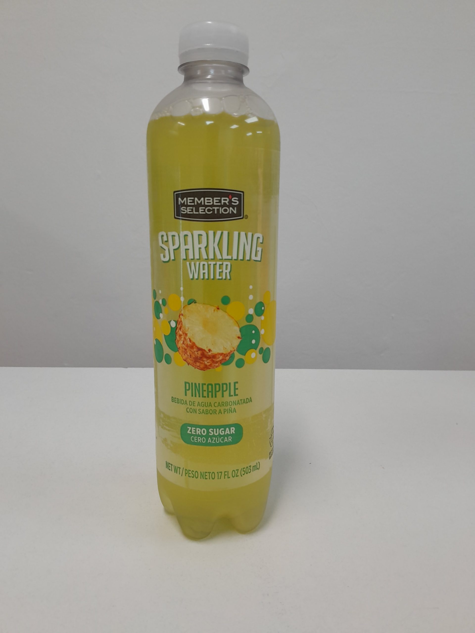 Member’s Selection Pineapple sparkling water zero sugar 17 oz bottle, carbonated pineapple flavored drink, front view on white background.